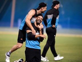 New Zealand’s Daryl Mitchell and Martin Guptill (top) share a light moment during a practice session in Dubai yesterday.