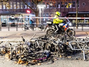 This photograph taken on Nov. 20, 2021 shows burned bikes after a protest against the partial lockdown and against the 2G government policy in Rotterdam.