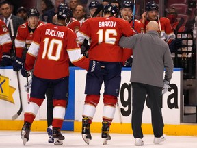 Florida Panthers centre Aleksander Barkov (16) is helped off the ice by left wing Anthony Duclair (10) and a team trainer after an apparent injury against the New York Islanders at FLA Live Arena.