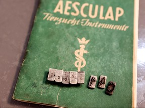 The dies from a tattoo kit, and a manual, are displayed at an Israeli auction house which says they were used on inmates at Auschwitz death camp, in Gilo, a Jewish settlement in the Israeli-Occupied West Bank on Nov. 2, 2021.