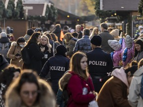 Police officers monitor compliance with the lockdown in Innsbruck's old town during the first day of a nationwide lockdown for people not yet vaccinated against COVID-19 on Nov. 15, 2021 in Innsbruck, Austria.