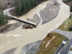 A swollen creek flows under a washed out bridge at the Carolin Mine interchange with Coquihalla Highway 5 after devastating rain storms caused flooding and landslides, near Hope, British Columbia, November 17, 2021.