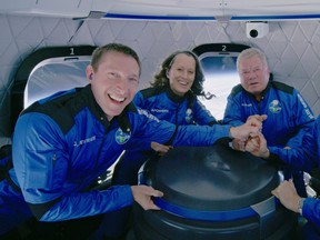 Star Trek actor William Shatner poses with Audrey Powers, Blue Origin's vice-president of mission and flight operations and a former NASA flight controller and engineer; and Glen de Vries, the co-founder of Medidata Solutions, a life science company during the Blue Origin New Shepard mission NS-18 suborbital flight near Van Horn, Texas, Oct. 13, 2021.