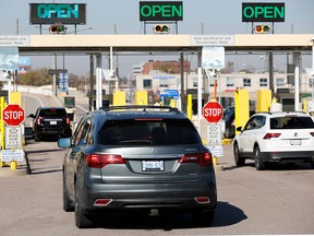 Vehicles with Canadian plates pass through the United States Customs booth at the Ambassador Bridge that connects Detroit and Windsor on November 8, 2021 in Detroit, Michigan.