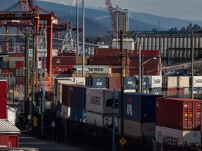Cargo containers sit on idle train cars at port in Vancouver on Feb. 21, 2020.
