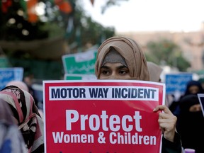 A supporter of religious and political party Jamaat-e-Islami (JI) carries a sign against a gang rape that occurred along a highway, and to condemn the violence against women and girls, during a demonstration in Karachi, Pakistan September 11, 2020.