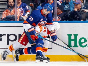 Zdeno Chara of the New York Islanders checks Blake Coleman of the Calgary Flames during the second period at the UBS Arena on November 20, 2021 in Elmont, New York.