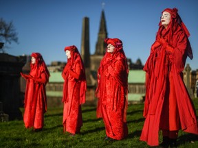 An Extinction Rebellion activist is seen crying during a Funeral for COP26 at the Necropolis on Nov. 13, 2021 in Glasgow, Scotland.