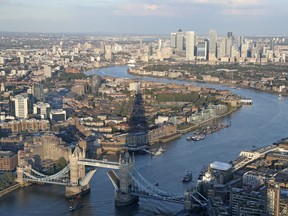 The Shard skyscraper casts a shadow as a tall ship sails down the River Thames towards an open Tower Bridge in London Thursday Sept. 16, 2021.