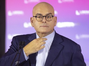 Ontario Liberal Party Leader Steven Del Duca adjusts his collar as he takes a journalist's question at the party's AGM in Toronto, Sunday, Oct. 17, 2021.