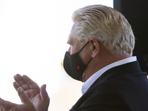Ontario Premier Doug Ford applauds during a ground breaking ceremony marking the start of a $41.3 million expansion project at Nestle Canada's ice cream factory in London, Ont., Friday, Nov. 5, 2021.