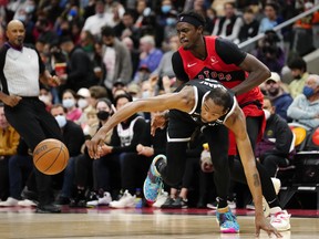 Toronto Raptors forward Pascal Siakam (right) picks up a foul on Brooklyn Nets forward Kevin Durant as they fight for a loose ball during second half NBA basketball action in Toronto on Sunday, Nov. 7, 2021.
