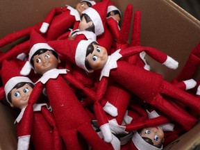 Elf on the Shelf figures are piled in a box at the company's studio in Atlanta.