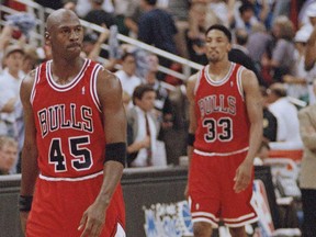 In this May 7, 1995, file photo, Chicago Bulls guard Michael Jordan (45) and forward Scottie Pippen (33) walk back to the bench during a timeout in the closing seconds of an NBA basketball playoff game in Orlando.