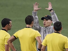 Los Angeles FC coach Bob Bradley, right, has words with officials after the Seattle Sounders defeated LAFC 3-0 in an MLS soccer match Friday, Sept. 18, 2020, in Seattle.