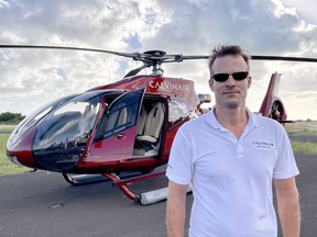 CalvinAir Helicopters CEO Mark Fleming standing in front of one of many helicopters used by the tour company.