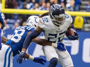 Tennessee Titans running back Derrick Henry runs the ball while Indianapolis Colts middle linebacker Bobby Okereke defends in overtime at Lucas Oil Stadium in Indianapolis, Ind., Oct. 31, 2021.