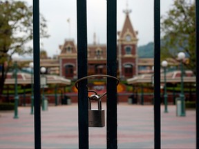 In this Jan. 26, 2020 file photo, a locked gate is seen after the Hong Kong Disneyland theme park has been closed, following the coronavirus outbreak in Hong Kong.