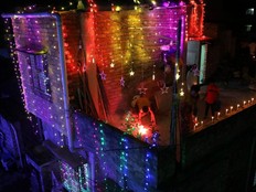 Residents light candles and fireworks on the rooftop of their house to celebrate Diwali, the festival of lights, in Kolkata, India, Thursday, Nov. 4, 2021.
