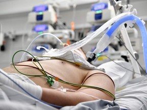 In this file photo taken on Nov. 17, 2021, medical equipment is seen as a patient lies in his bed on an intensive care unit (ICU) at a hospital of the Salzburg state clinics in Salzburg, Austria.