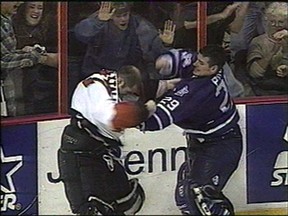 Maple Leafs goalie Felix Potvin pounds the stuffing out of Flyers goalie Ron Hextall during a donnybrook at the end of the game.