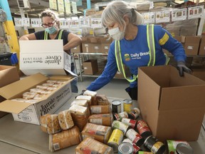 Toronto Daily Bread Food Bank volunteers Leslie Vine (L) and Lori Findlay are pictured as they sort food on Nov. 16, 2021