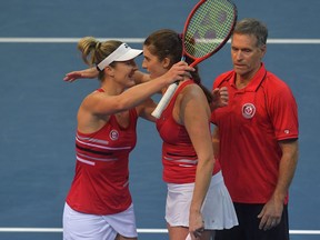 Rebecca Marino, right, and Gabriela Dabrowski of Canada celebrate after winning their group match against Alize Cornet and Clarta Burel of France during the Billie Jean King Cup finals between France and Canada on Nov. 1, 2021 in Prague.