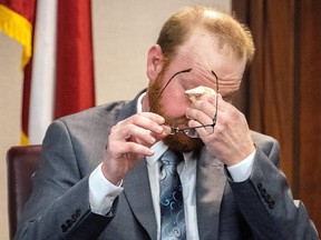 Travis McMichael reacts to questions during his testimony at the trial of Greg McMichael, his son Travis McMichael and William "Roddie" Bryan in the Glynn County Courthouse, as the murder trial over the killing of Ahmaud Arbery continues, in Brunswick, Ga., Nov. 17, 2021.