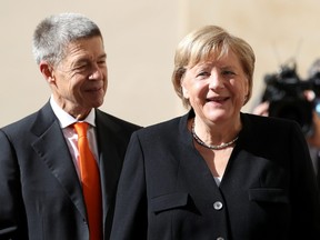 German Chancellor Angela Merkel and her husband Joachim Sauer arrive ahead of a meeting with Pope Francis at the Vatican, Oct. 7, 2021.