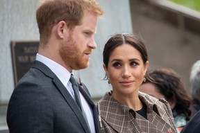 Prince Harry, Duke of Sussex and Meghan, Duchess of Sussex (Woko Ono) lay ferns and a wreath at the tomb of the Unknown Warrior at the newly unveiled UK war memorial and Pukeahu National War Memorial Park, on October 28, 2018, in Wellington, New Zealand.