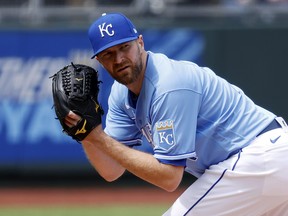 Pitcher Wade Davis of the Kansas City Royals checks a runner on first during the game against the Toronto Blue Jays at Kauffman Stadium on April 17, 2021 in Kansas City, Miss.