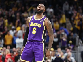 LeBron James #6 of the  Los Angeles Lakers celebrates in the 124-116 OT win against the Indiana Pacers at Gainbridge Fieldhouse on November 24, 2021 in Indianapolis, Indiana.