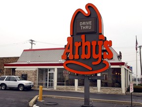 An SUV sits at the pick-up window of an Arby's restaurant in Des Plaines, Illinois.