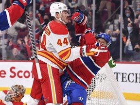 Calgary Flames defender Erik Gudbranson knocks down Canadiens forward Brendan Gallagher on Thursday night. GETTY IMAGES