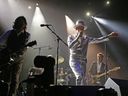 The late, great Gord Downie, centre, performs with The Tragically Hip in Edmonton in 2016. The band re-releases its iconic Road Apples album in digital form on Friday. POSTMEDIA FILES