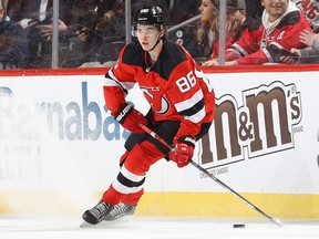 Jack Hughes of the New Jersey Devils takes the puck in the third period against the Florida Panthers at Prudential Center on February 11, 2020 in Newark, New Jersey.