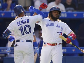 Marcus Semien of the Toronto Blue Jays celebrates his home run with Vladimir Guerrero Jr. during a game against the Minnesota at the Rogers Centre on September 18, 2021 in Toronto.