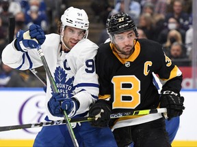 Toronto Maple Leafs forward John Tavares battles for position with Boston Bruins forward Patrice Bergeron in the second period at Scotiabank Arena in Toronto, Nov. 6, 2021.