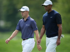Justin Thomas, left, and Tiger Woods walk down the 12th fairway during the first round of the U.S. Open golf tournament at Winged Foot Golf Club - West in Mamaroneck, N.Y., Sept. 17, 2020.