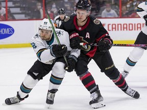 Ottawa Senators left wing Brady Tkachuk (7) battles with San Jose Sharks right wing Kevin Labanc (62) during third period action at the Canadian Tire Centre on October 21,2021.