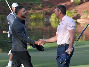Brooks Koepka (left) and Bryson DeChambeau shake hands on the ninth green after Capital One's The Match V: Bryson v Brooks at Wynn Golf Course on November 26, 2021 in Las Vegas.