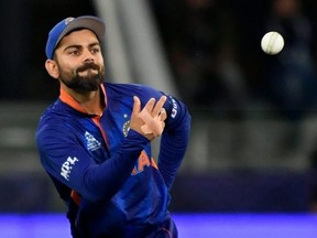 India's captain Virat Kohli throws the ball during the ICC mens Twenty20 World Cup cricket match between India and Namibia at the Dubai International Cricket Stadium in Dubai. Getty Images