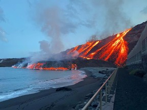 Lava spewed by Cumbre Vieja volcano reaches the Atlantic Ocean at Los Guirres beach in this handout image released by Spanish Transport Ministry on the Canary Island of La Palma, Spain, Wednesday, Nov. 10, 2021.