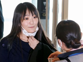 Mako Komuro, former Japan's Princess Mako and the eldest daughter of Crown Prince Akishino and Crown Princess Kiko, is seen before she and her newly married husband Kei before they board a flight bound for New York to start their new life in the U.S. at Haneda airport in Tokyo, Japan November 14, 2021.