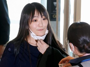 Mako Komuro, Japan's former Princess Mako and the eldest daughter of Crown Prince Akishino and Crown Princess Kiko, is seen before she and her newly married husband Kei before they board a flight bound for New York City to start their new life in the U.S., at Haneda airport in Tokyo, Sunday, Nov. 14, 2021.