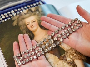 A staff displays a pair of diamond bracelets, with approximately 140 to 150 carats and owned by Queen Marie-Antoinette of France, in silver and yellow gold, circa 1776, during a preview at Christie's before their auction sale in Geneva, Switzerland, Nov. 3, 2021.