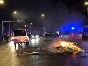 A photo shows a fire in a street of The Hague during a demonstration against the Dutch government's coronavirus measures, on November 20, 2021.