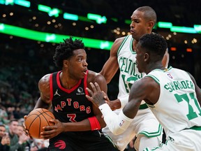 Raptors' OG Anunoby looks for an opening against Celtics' Dennis Schroder and Al Horford in the first quarter at TD Garden on Wednesday, Nov. 10, 2021.