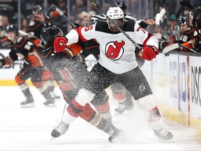 P.K. Subban of the New Jersey Devils checks Sonny Milano of the Anaheim Ducks during the first period of a game at Honda Center on Nov. 2, 2021 in Anaheim, Calif.