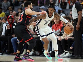 Memphis Grizzles guard Ja Morant (12) dribbles as Toronto Raptors guard Fred VanVleet (23) defends during the first half at FedExForum.